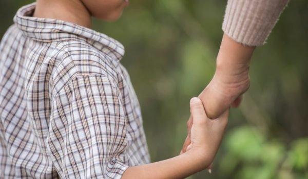 close-up-happy-mum-son-holding-hand-park-family-concept_1150-4796