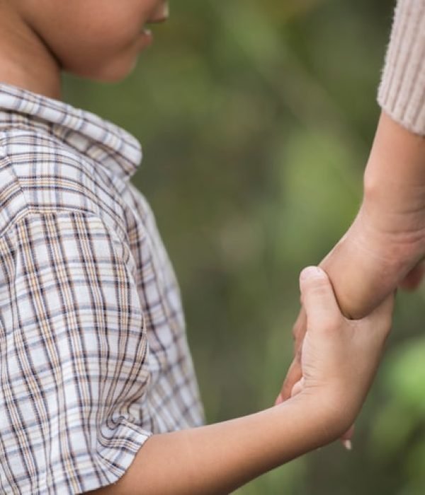 close-up-happy-mum-son-holding-hand-park-family-concept_1150-4796