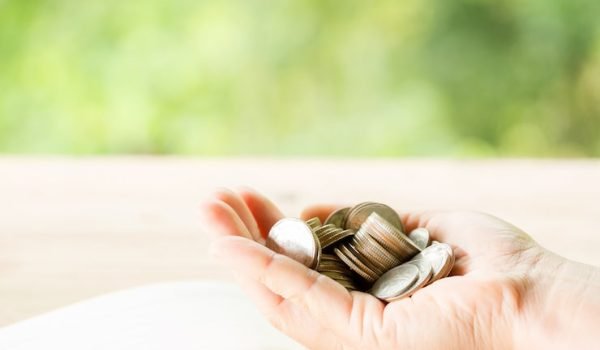 woman-s-hand-is-holding-many-coins_1150-17735